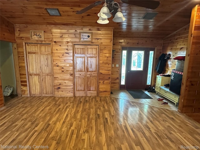 5150 Lafave Rd, Black River, MI 48721 - entrance foyer with ceiling fan, wood finished floors, wooden ceiling, wooden walls, and vaulted ceiling