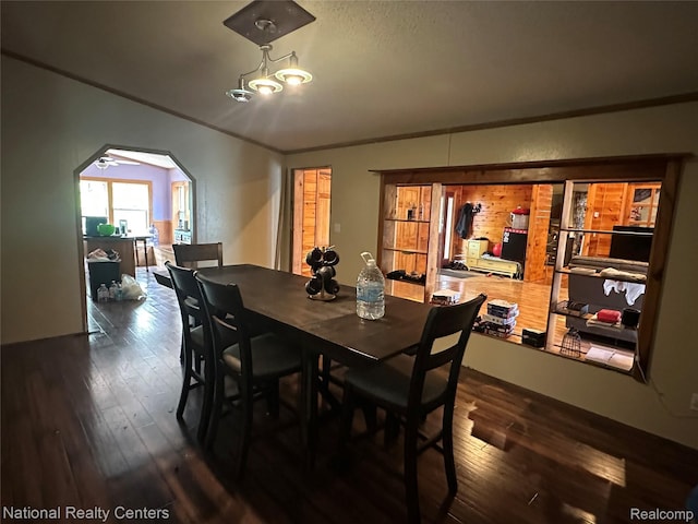 5150 Lafave Rd, Black River, MI 48721 - dining area featuring ornamental molding, dark wood-style floors, and arched walkways