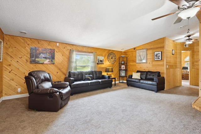 2536 Meridian Rd, Lewiston, MI 49756 - carpeted living room with a ceiling fan, wood walls, lofted ceiling, and a textured ceiling