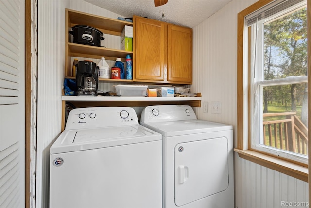 2536 Meridian Rd, Lewiston, MI 49756 - laundry room featuring cabinet space, independent washer and dryer, wallpapered walls, and a textured ceiling