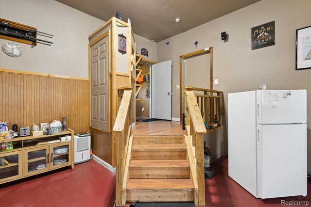 2536 Meridian Rd, Lewiston, MI 49756 - staircase with a wainscoted wall and wood walls