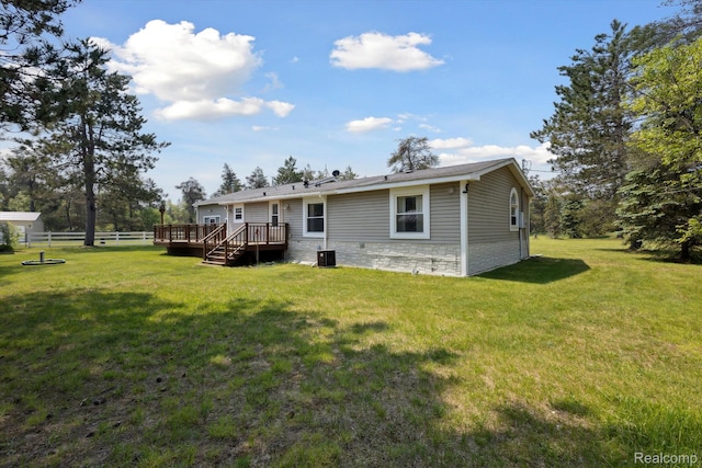 2536 Meridian Rd, Lewiston, MI 49756 - back of property featuring a wooden deck and stone siding