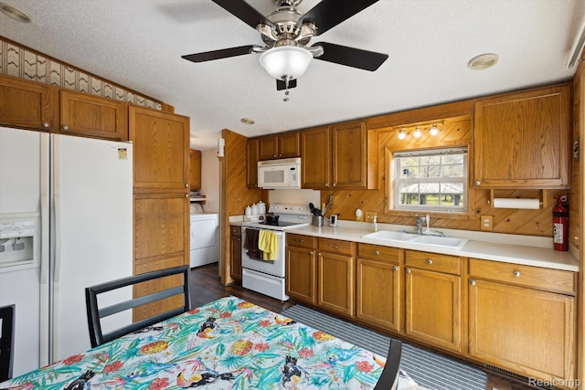 2536 Meridian Rd, Lewiston, MI 49756 - kitchen featuring white appliances, light countertops, washer / clothes dryer, a textured ceiling, and brown cabinets