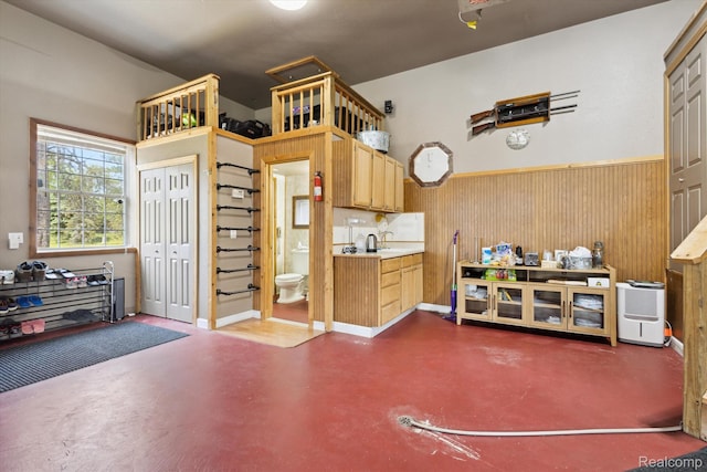 2536 Meridian Rd, Lewiston, MI 49756 - kitchen with concrete floors, a wainscoted wall, light countertops, and wood walls