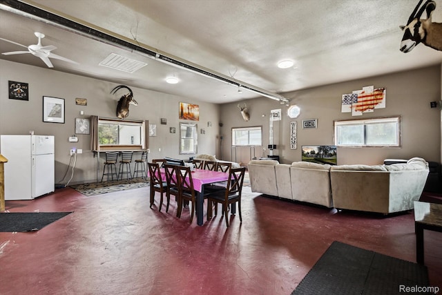 2536 Meridian Rd, Lewiston, MI 49756 - dining room with concrete flooring and ceiling fan