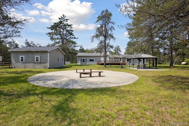 2536 Meridian Rd, Lewiston, MI 49756 - back of house featuring a gazebo, a lawn, and a patio