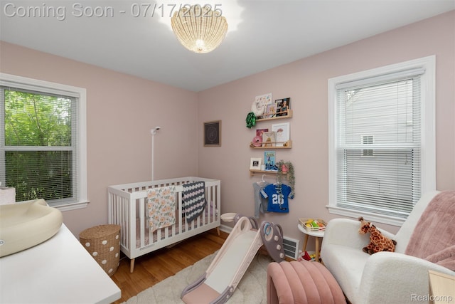 518 Roth Blvd, Clawson, MI 48017 - bedroom featuring wood finished floors and a crib