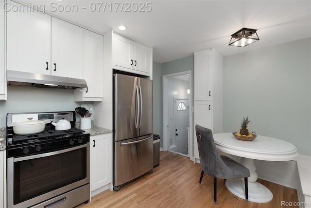 518 Roth Blvd, Clawson, MI 48017 - kitchen featuring appliances with stainless steel finishes, under cabinet range hood, white cabinets, light wood finished floors, and light stone counters