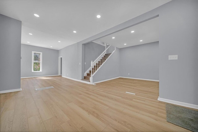 408 Mount Vernon St, Detroit, MI 48202 - unfurnished living room featuring stairway, light wood-style flooring, baseboards, and recessed lighting