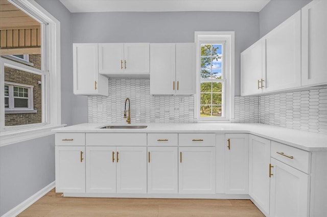 408 Mount Vernon St, Detroit, MI 48202 - kitchen with a sink, white cabinets, light countertops, and light wood finished floors