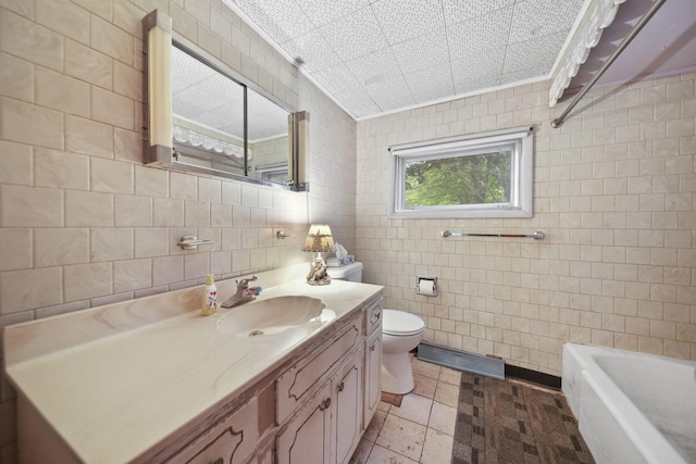 538 S Jackson St, Hanover, MI 49241 - bathroom with tile walls, vanity, toilet, and a bathtub