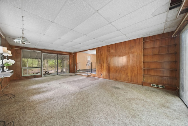 538 S Jackson St, Hanover, MI 49241 - carpeted spare room featuring wood walls and built in features