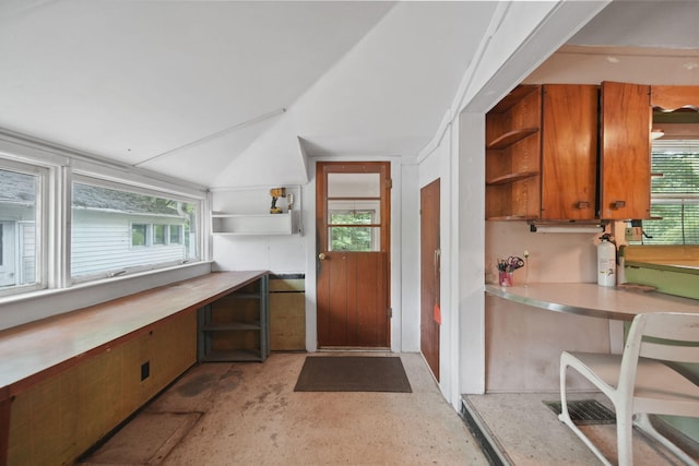 538 S Jackson St, Hanover, MI 49241 - kitchen with open shelves, brown cabinetry, light countertops, healthy amount of natural light, and vaulted ceiling