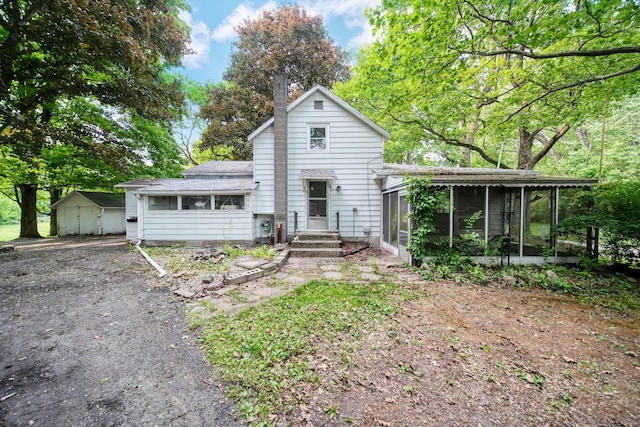 538 S Jackson St, Hanover, MI 49241 - view of front of house featuring a sunroom and a chimney