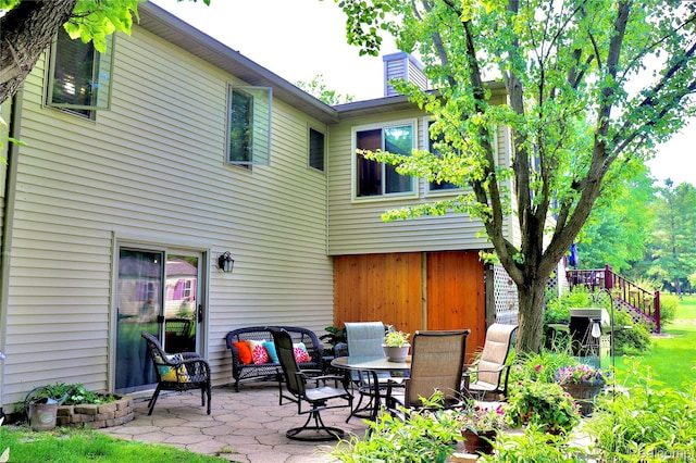 1149 Highview Dr, Lapeer, MI 48446 - back of house featuring a patio and a chimney