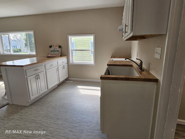 3705 Gratiot Ave, Flint, MI 48503 - kitchen with white cabinetry and a peninsula