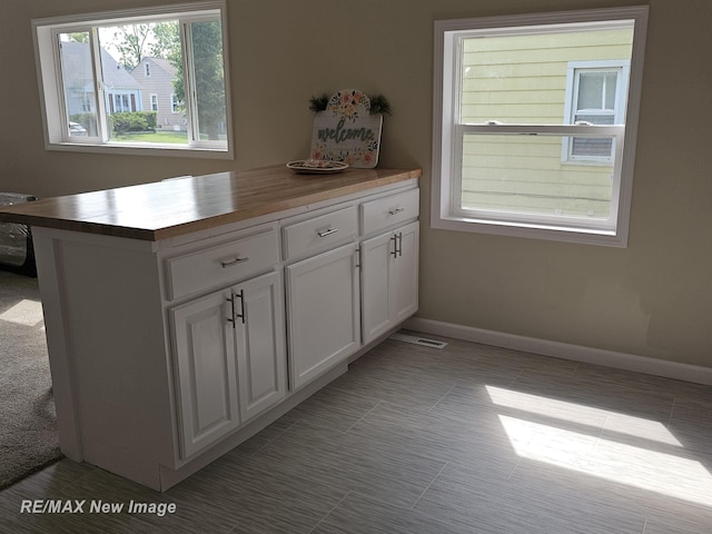 3705 Gratiot Ave, Flint, MI 48503 - kitchen featuring wood counters, white cabinets, and tile patterned floors