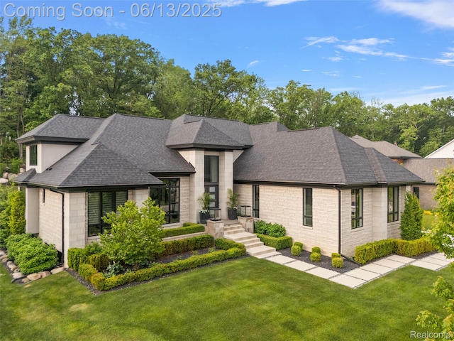 212 Enclave Ct, Rochester Hills, MI 48306 - view of front of home featuring a shingled roof, stone siding, and a front lawn