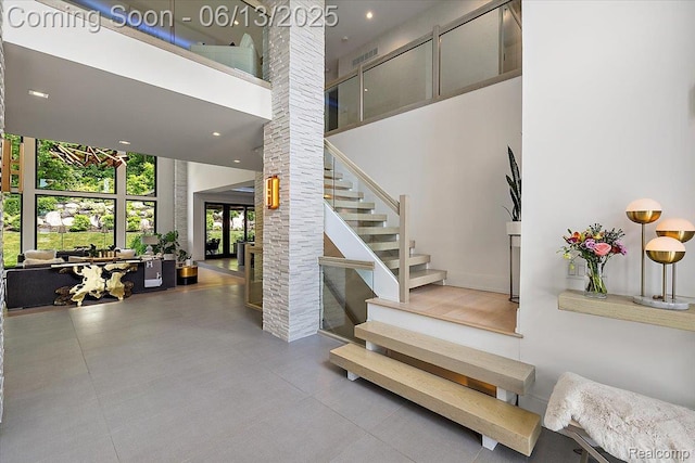 212 Enclave Ct, Rochester Hills, MI 48306 - staircase with a towering ceiling, decorative columns, and recessed lighting