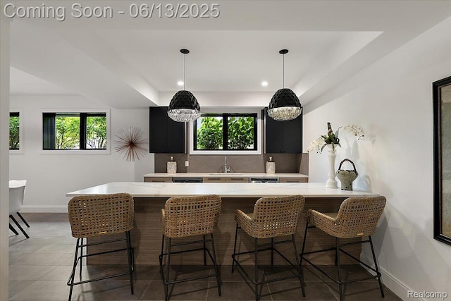 212 Enclave Ct, Rochester Hills, MI 48306 - kitchen featuring baseboards, plenty of natural light, tasteful backsplash, a breakfast bar, and recessed lighting