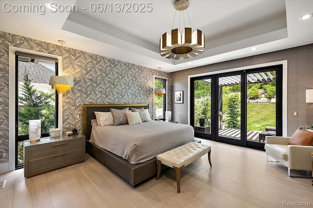 212 Enclave Ct, Rochester Hills, MI 48306 - bedroom with wallpapered walls, access to exterior, a raised ceiling, light wood-type flooring, and a chandelier