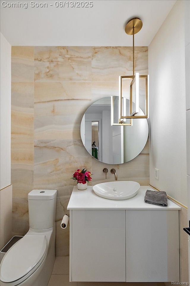 212 Enclave Ct, Rochester Hills, MI 48306 - half bathroom featuring vanity, toilet, and tile walls
