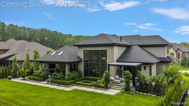 212 Enclave Ct, Rochester Hills, MI 48306 - back of property with stone siding, a patio, and a shingled roof
