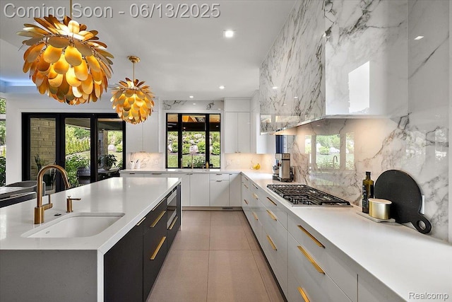 212 Enclave Ct, Rochester Hills, MI 48306 - kitchen featuring a sink, backsplash, white cabinets, light countertops, and appliances with stainless steel finishes