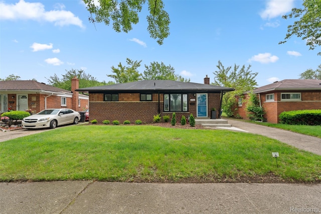 30112 Matthew St, Westland, MI 48186 - view of front of property featuring a chimney, a front lawn, brick siding, and concrete driveway