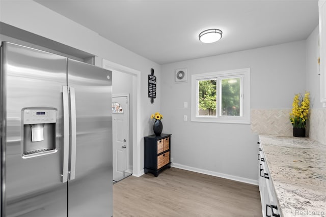 30112 Matthew St, Westland, MI 48186 - kitchen featuring stainless steel fridge with ice dispenser, light wood-style flooring, baseboards, light stone countertops, and white cabinetry