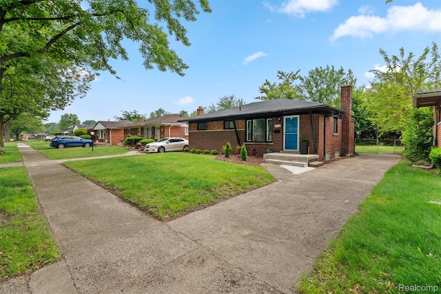 30112 Matthew St, Westland, MI 48186 - view of front facade with a chimney, brick siding, a front yard, and driveway