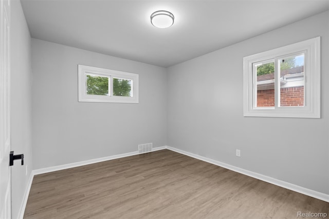 30112 Matthew St, Westland, MI 48186 - empty room featuring plenty of natural light, wood finished floors, and baseboards