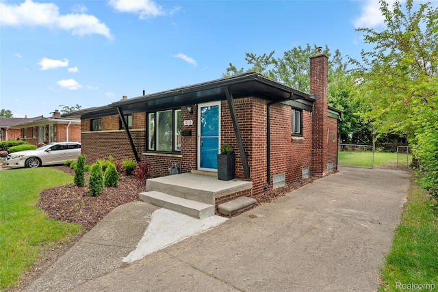 30112 Matthew St, Westland, MI 48186 - view of front of home with brick siding, a chimney, and concrete driveway