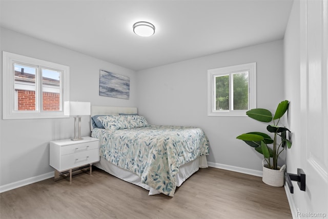 30112 Matthew St, Westland, MI 48186 - bedroom featuring multiple windows, light wood finished floors, and baseboards