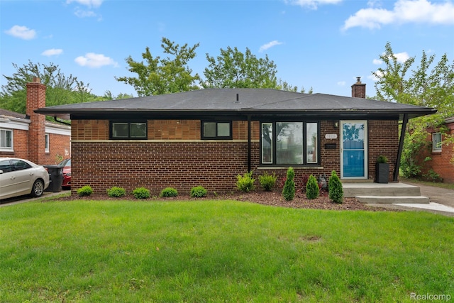 30112 Matthew St, Westland, MI 48186 - view of front facade featuring a chimney, brick siding, and a front yard