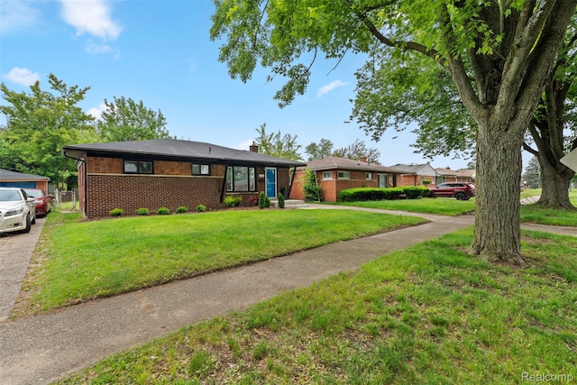 30112 Matthew St, Westland, MI 48186 - ranch-style house featuring brick siding, a front lawn, a chimney, and driveway
