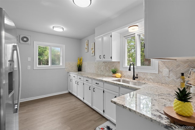30112 Matthew St, Westland, MI 48186 - kitchen with a sink, stainless steel fridge with ice dispenser, white cabinets, and light stone counters