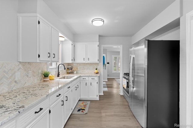 30112 Matthew St, Westland, MI 48186 - kitchen featuring appliances with stainless steel finishes, a sink, and white cabinets