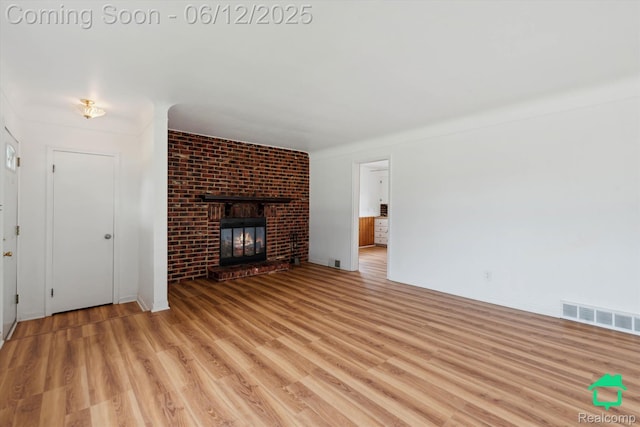 32703 Anita Dr, Westland, MI 48185 - unfurnished living room featuring light wood finished floors and a fireplace