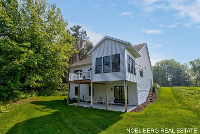 18153 Newgate Ln, Spring Lake, MI 49456 - rear view of property featuring a patio, a lawn, a shingled roof, and a wooden deck