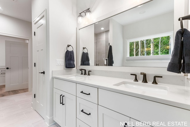 18153 Newgate Ln, Spring Lake, MI 49456 - bathroom featuring double vanity, a tile shower, and recessed lighting