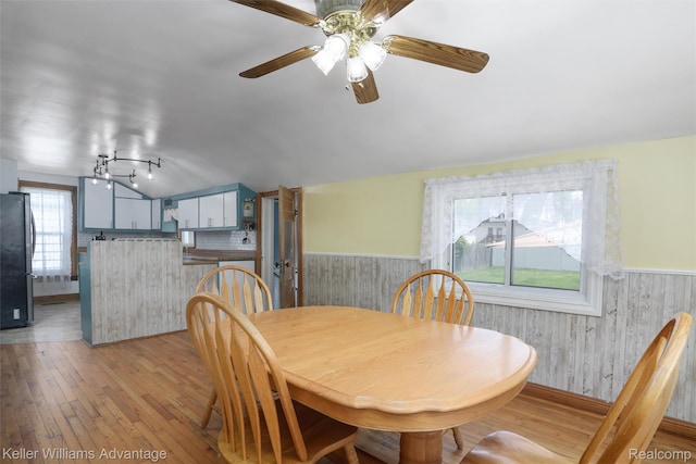 2931 4th St, Trenton, MI 48183 - dining area with wainscoting, light wood-style floors, ceiling fan, and vaulted ceiling