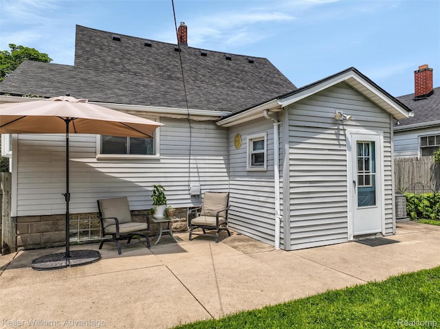 2931 4th St, Trenton, MI 48183 - rear view of house with a patio area and roof with shingles