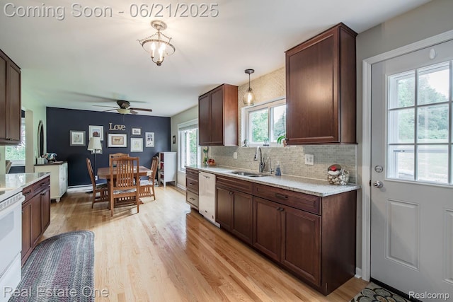 1400 W Predmore Rd, Oakland, MI 48363 - kitchen featuring white appliances, light countertops, light wood-style flooring, ceiling fan, and decorative backsplash