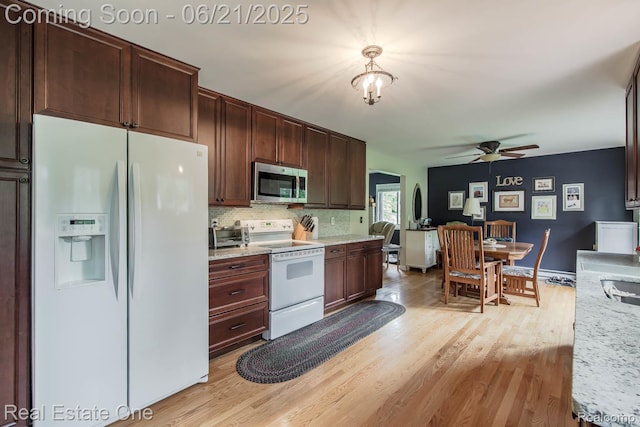 1400 W Predmore Rd, Oakland, MI 48363 - kitchen featuring white appliances, ceiling fan, light wood-style flooring, and decorative backsplash