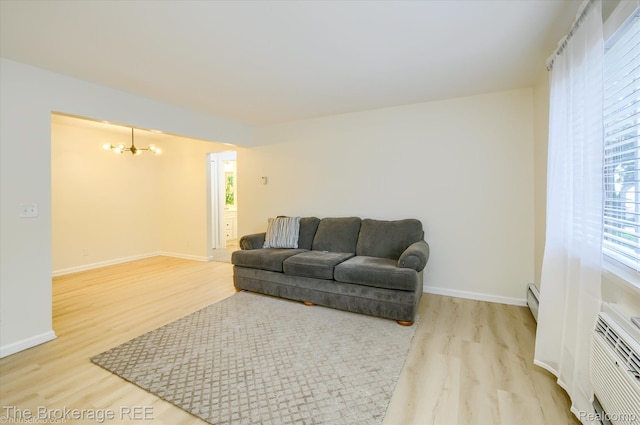 810 Plate St Unit 103, Rochester, MI 48307 - living room featuring a chandelier, light wood-style floors, and healthy amount of natural light
