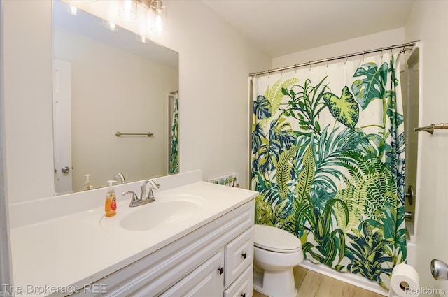 810 Plate St Unit 103, Rochester, MI 48307 - full bath with vanity, toilet, wood finished floors, and shower / bath combination with curtain