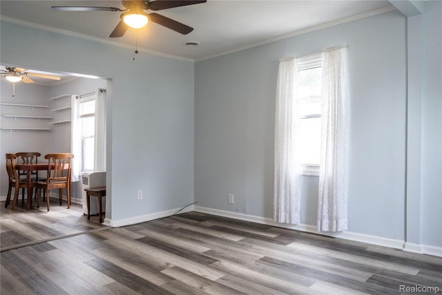 2910 Peerless Ave, Waterford, MI 48328 - unfurnished living room featuring ceiling fan, plenty of natural light, wood finished floors, crown molding, and baseboards