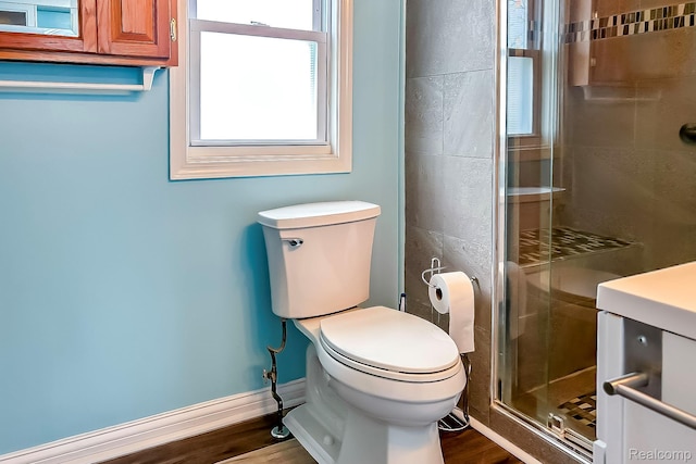 2910 Peerless Ave, Waterford, MI 48328 - full bathroom featuring a stall shower, toilet, wood finished floors, and baseboards