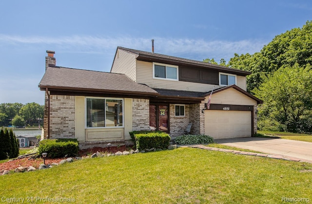4851 Shoreline Blvd, Waterford, MI 48329 - view of front of home with brick siding, a front lawn, an attached garage, concrete driveway, and a chimney